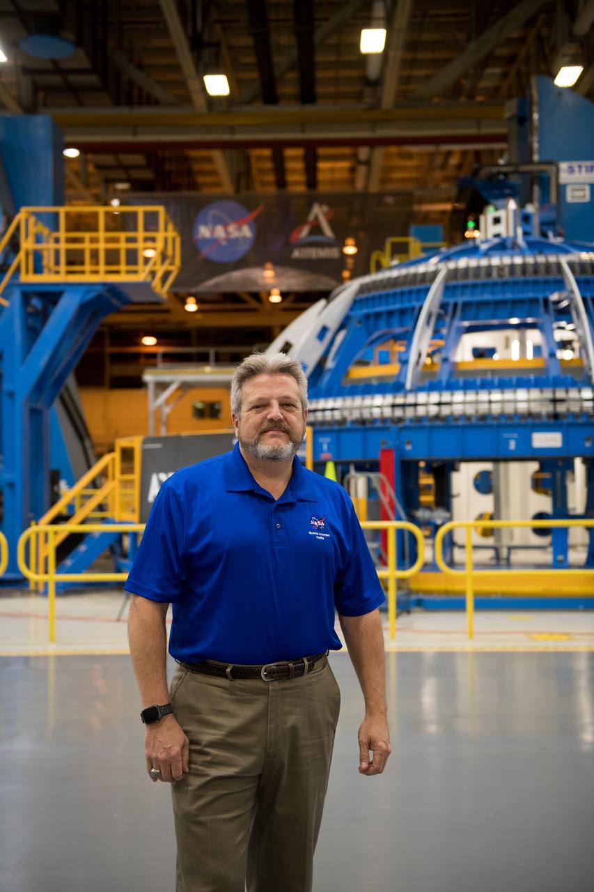 Robert Champion - Director NASA Michoud Assembly Facility stands in front of the Robotic Weld tool in BLDG 103.